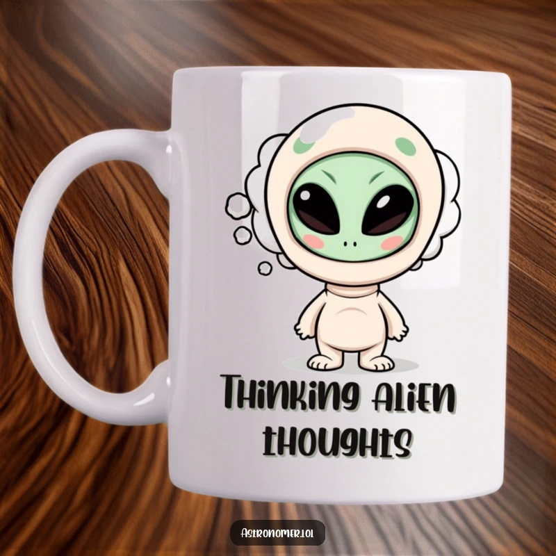 Funny mug with a curious character’s thought bubble containing a silly, cartoonish alien face, representing amusing extraterrestrial thoughts.