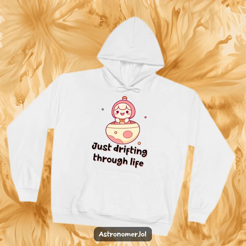 Funny Hoodie: A happy kawaii character is shown joyfully sailing on a planet, styled like a fun boat in the vast cosmos.