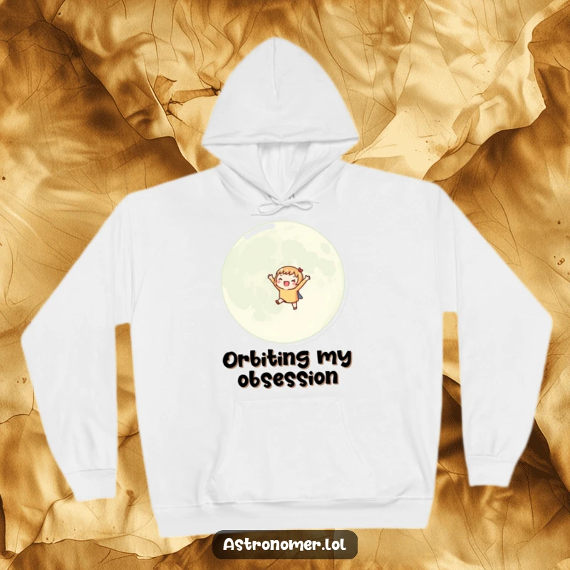 Funny hoodie depicting an excited character orbiting a giant moon with small arms outstretched, perfect for cozy celestial journeys.