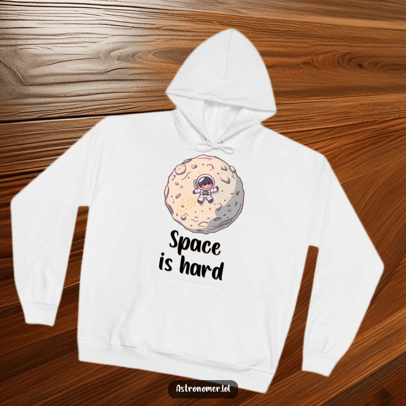 Funny hoodie showing a cartoon astronaut's spaceship comically crashing into a massive asteroid, a humorous depiction of a space mission gone wrong.