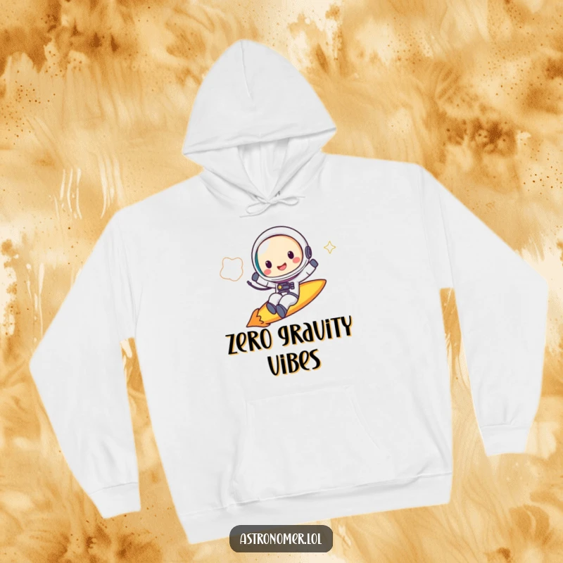 Funny Hoodie: A cheerful astronaut rides a comet with a big grin, embodying fun and cosmic travel.