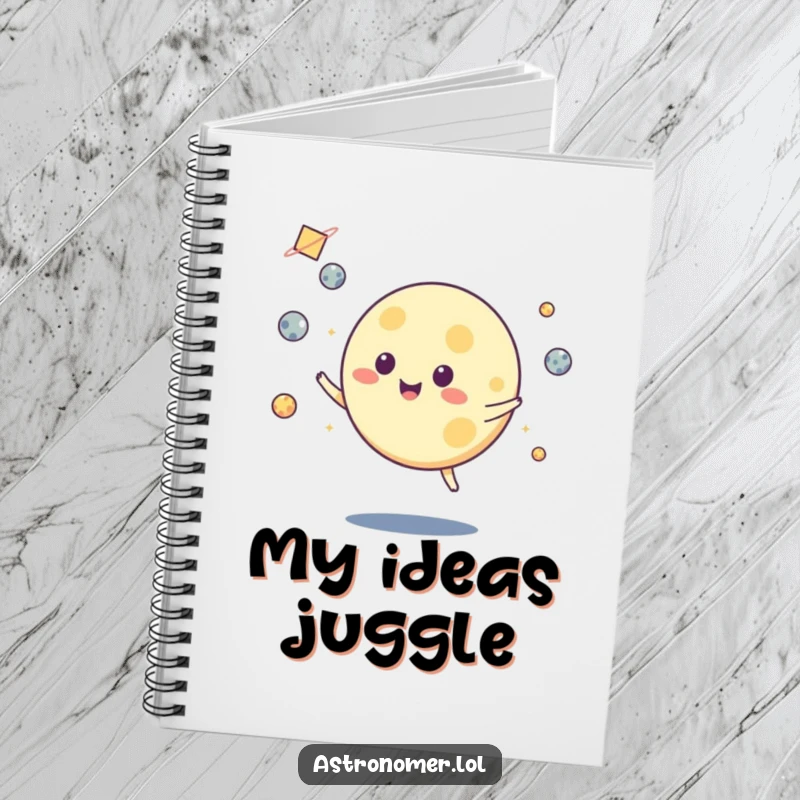 Funny notebook cover displaying a moon character juggling several small asteroids, ideal for taking notes with a cosmic flair.
