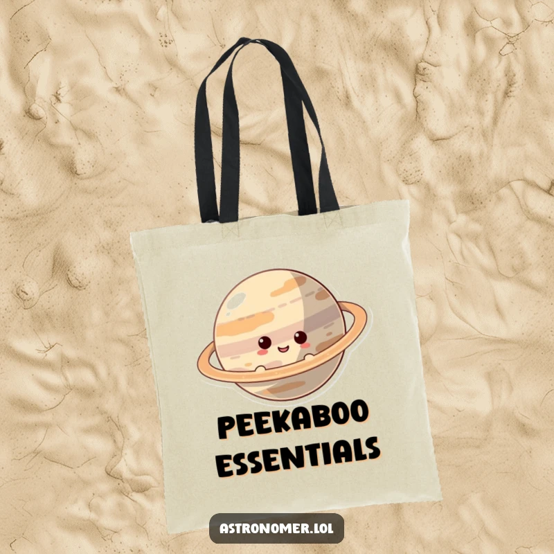 Funny Tote Bag: A smiling, curious character peeks from behind a majestically ringed planet, hinting at hidden wonders and fun.